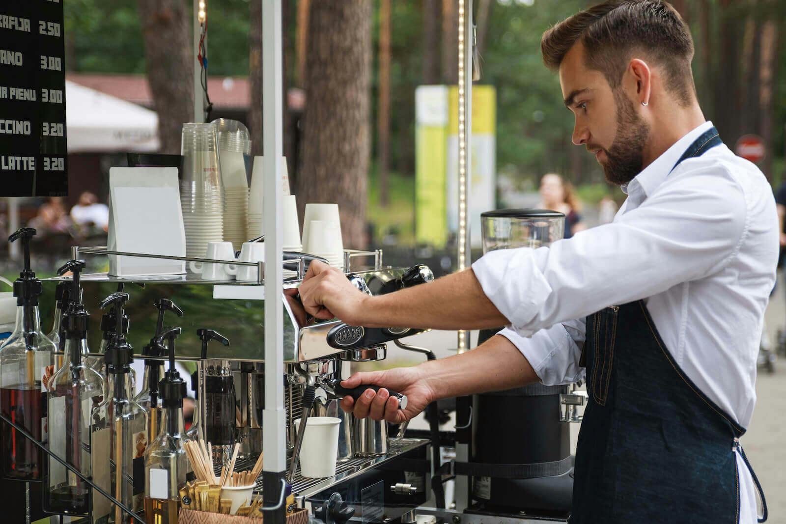 Caffeine dehydration: barista working at an outdoor coffee shop