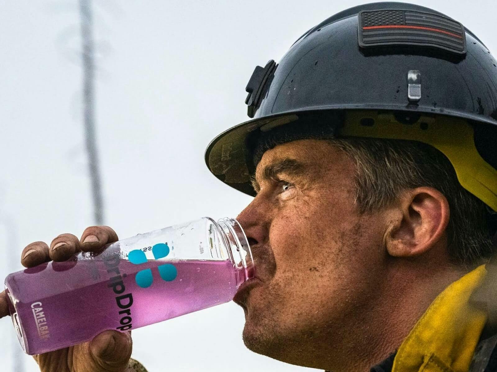 Electrolytes benefits: worker drinking DripDrop ORS