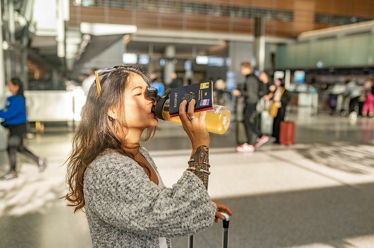 Pakt lp woman drinking dripdrop in airport